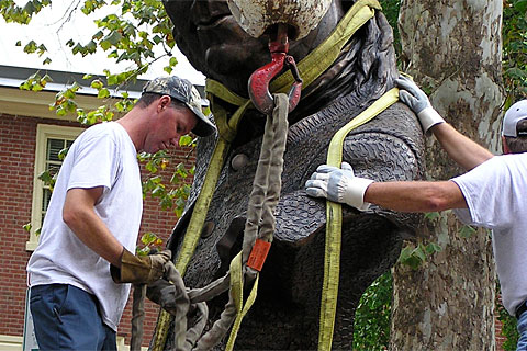Workers rig the sculpture for lifting -- by its neck.  'Keys To Community,' a nine-foot bronze bust of Ben Franklin for downtown Philadelphia