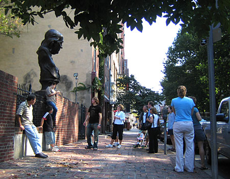 Passersby gawk at 'Keys To Community,' a bronze sculpture of Ben Franklin in downtown Philadelphia.